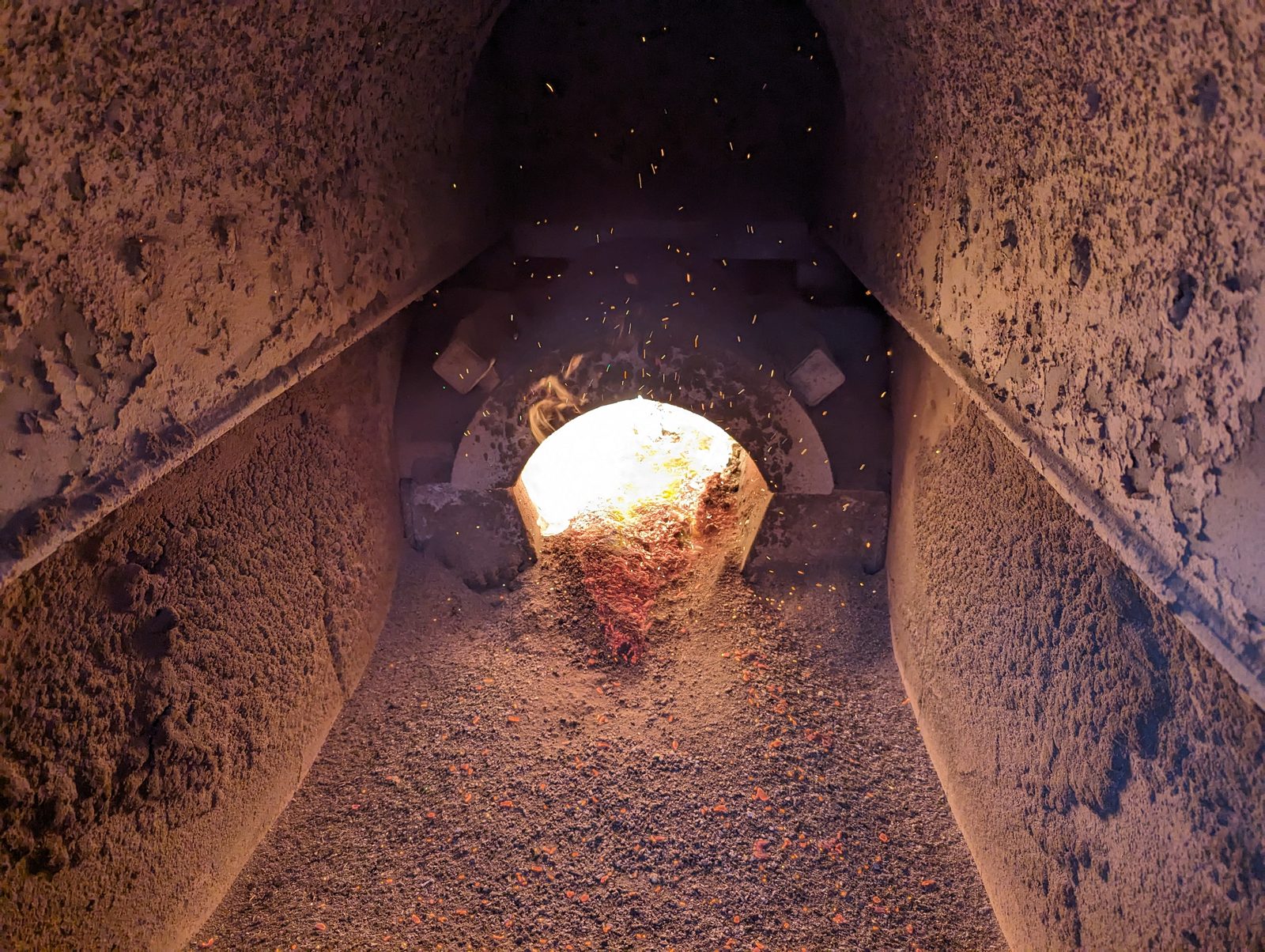 Site photograph looking into the combustion chamber of a Ranheat MSU 450 boiler showing a new fixed ceramic retort with a burning fuel bed