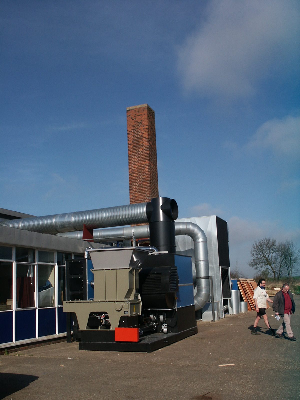 Installed Ranheat WA 300 warm air heater with hogger loader and galvanised warm-air ducting at A&J Sectional Building