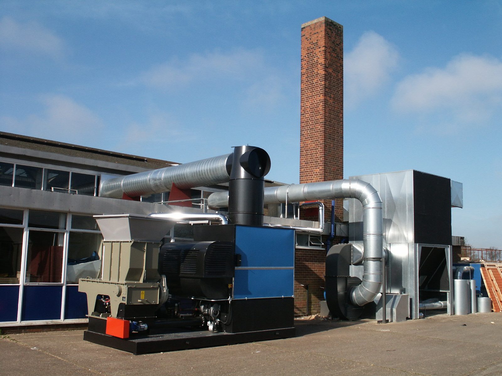 Perspective view of Ranheat WA 300 warm air heater with galvanised flue pipework and multi-cyclone at A&J Sectional Building