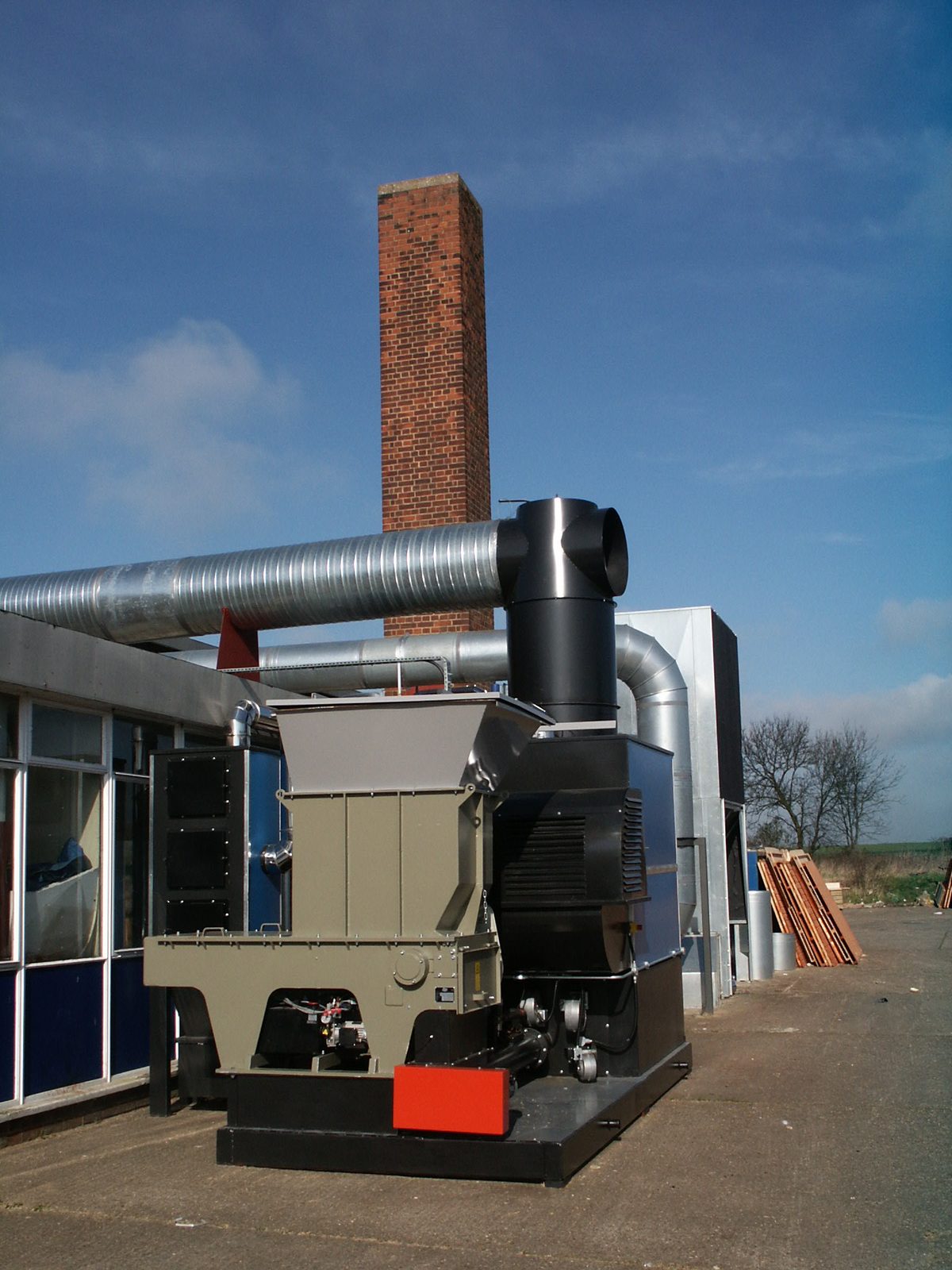 Front view of an installed Ranheat WA 300 warm air heater with hogger loader and galvanised ducting