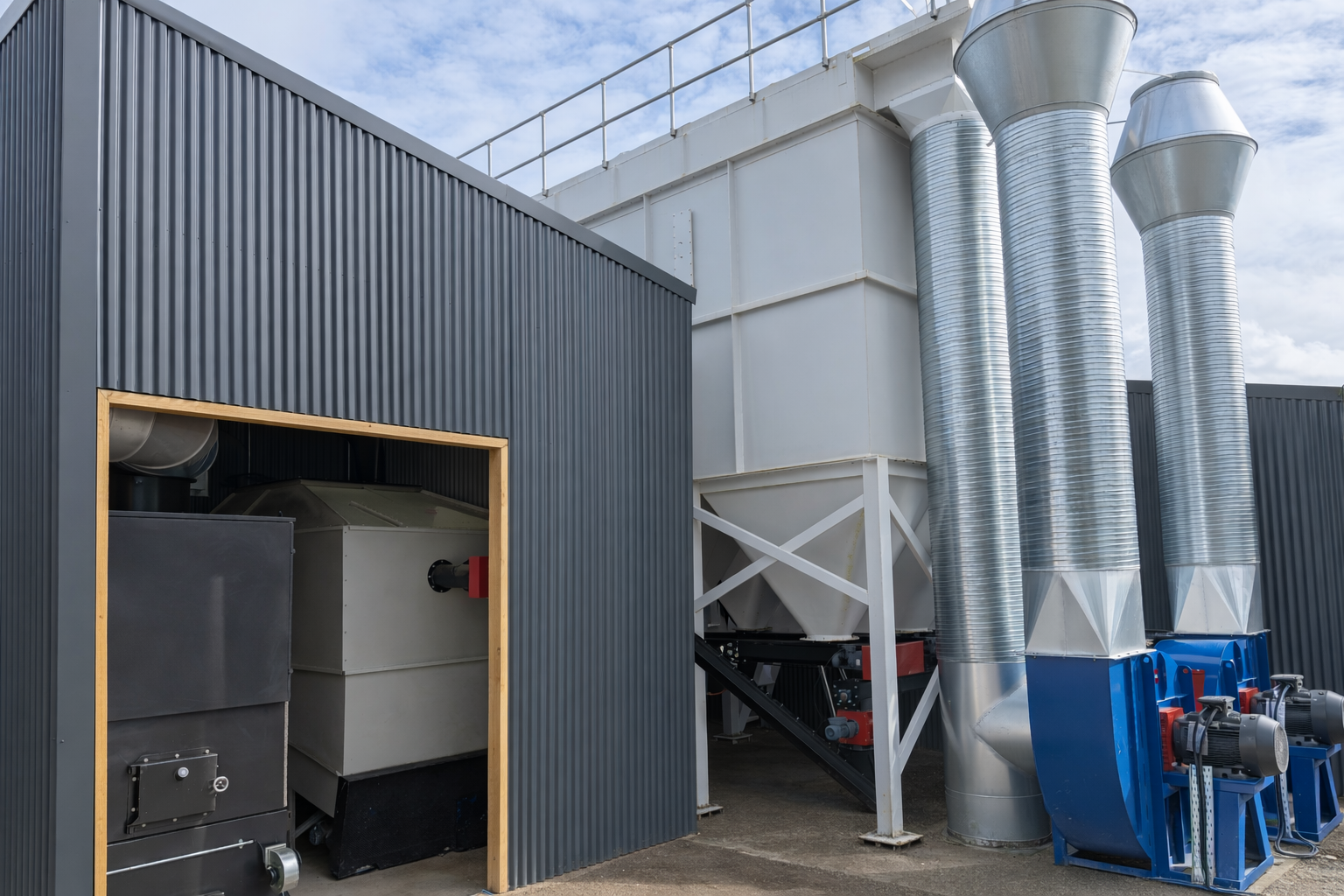 Site photograph of a Ranheat WA 300 warm air heater with a B10 bunker silo and twin cyclones installed at Savvy Kitchens